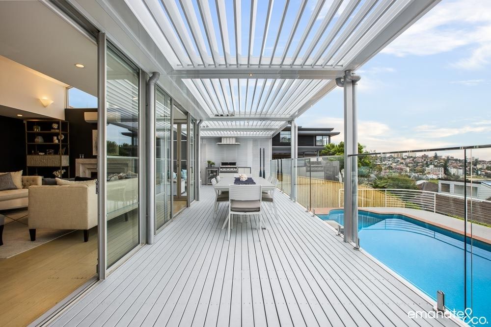 "Stunning alfresco area with an opening roof, poolside dining, and scenic views of the Northern Beaches."