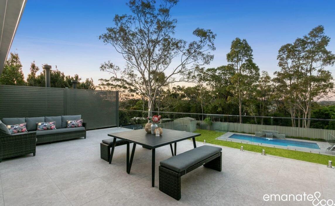 Expansive tiled deck outdoor living space with a stunning pool view in Berowra, Sydney.